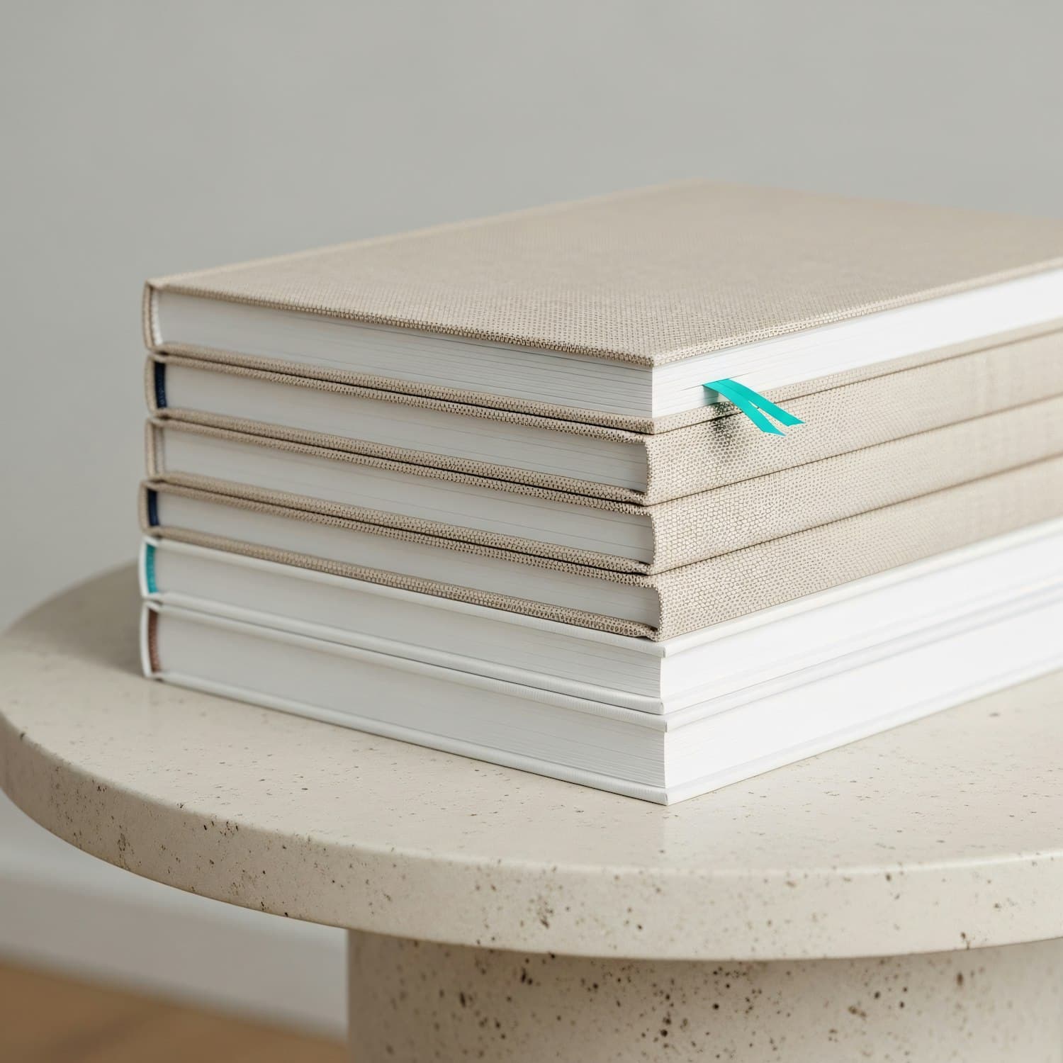 A stack of hardcover books with a ribbon bookmark